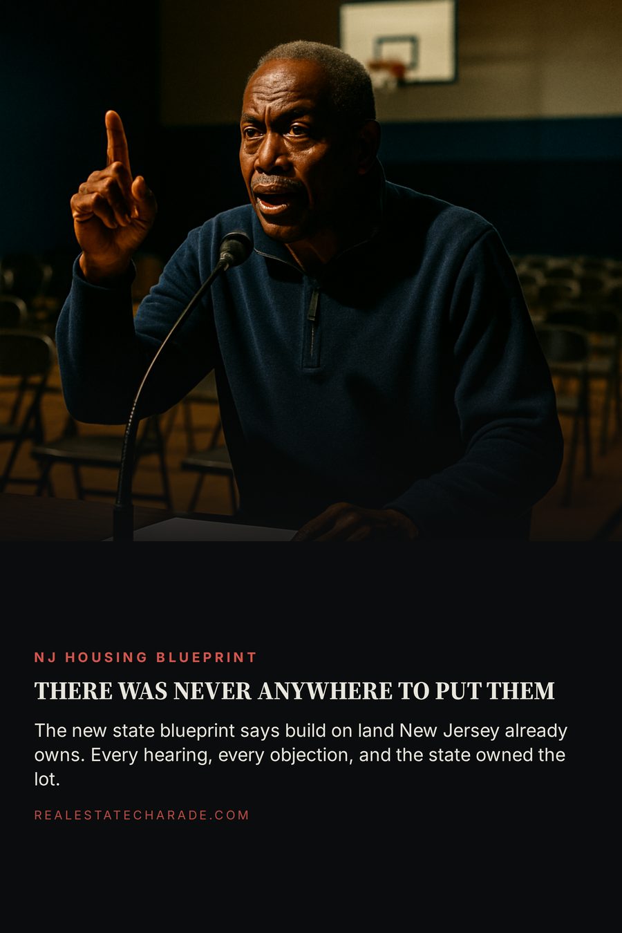 A man in a quarter-zip speaking into a microphone at a folding table in a nearly empty school gymnasium at night. Headline reads there was never anywhere to put them, with a line noting New Jersey's new blueprint calls for building on land the state already owns.